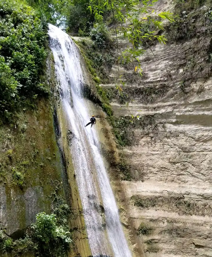 A guest rappelling down the middle of the 45-metre Dao Falls